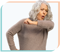 A middle-aged woman coughing into her elbow